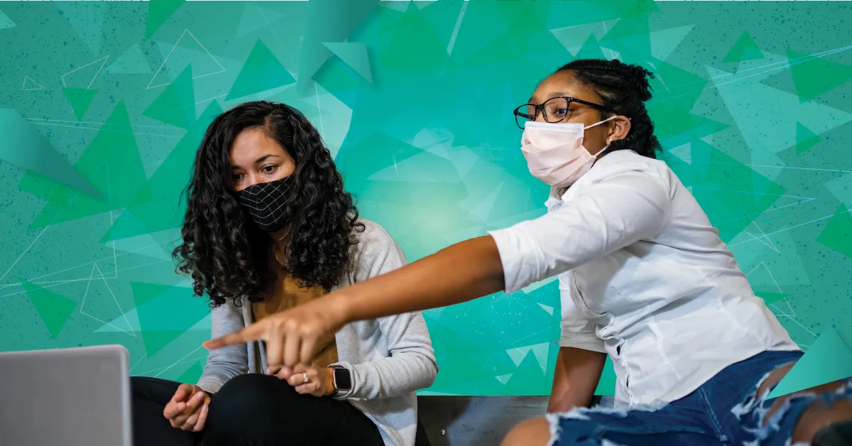 Two young women wearing face masks sit in front of a laptop. One points at the screen while the other watches attentively. They appear to be collaborating or learning together, with a green geometric background behind them.
